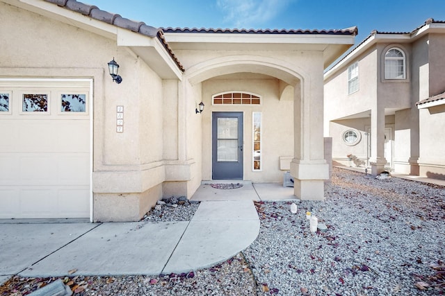 view of exterior entry featuring a garage