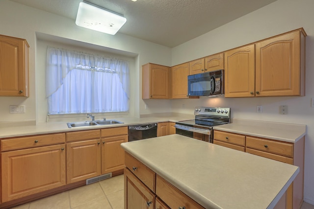 kitchen with light tile patterned floors, sink, and black appliances