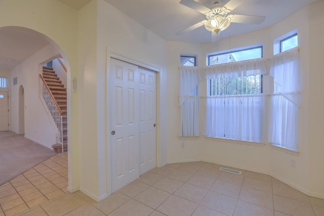 tiled foyer entrance featuring a wealth of natural light and ceiling fan