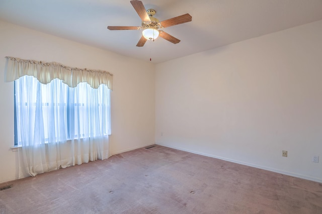 carpeted empty room featuring ceiling fan