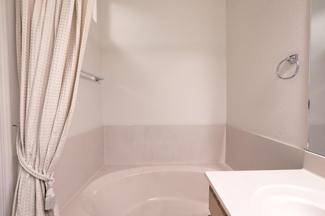 bathroom with a bathtub and vanity