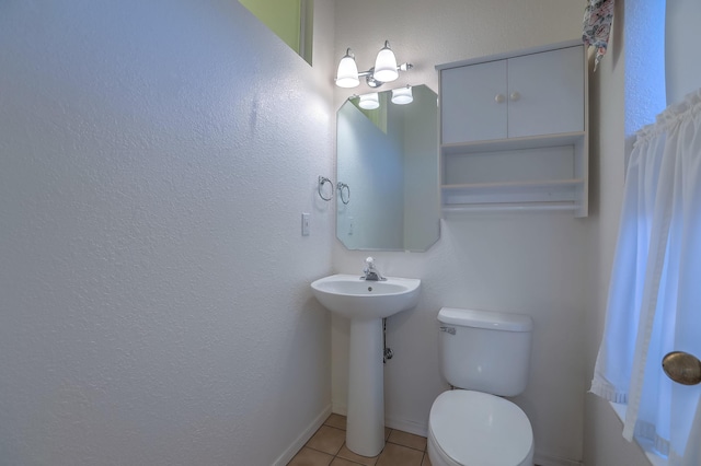 bathroom featuring sink, tile patterned flooring, and toilet