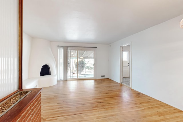 unfurnished living room with light hardwood / wood-style floors