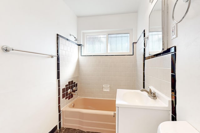 full bathroom with toilet, vanity, and tiled shower / bath combo