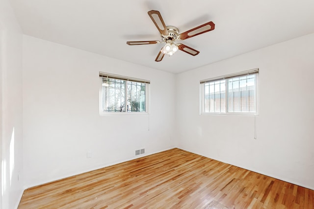 spare room featuring light wood-type flooring and ceiling fan