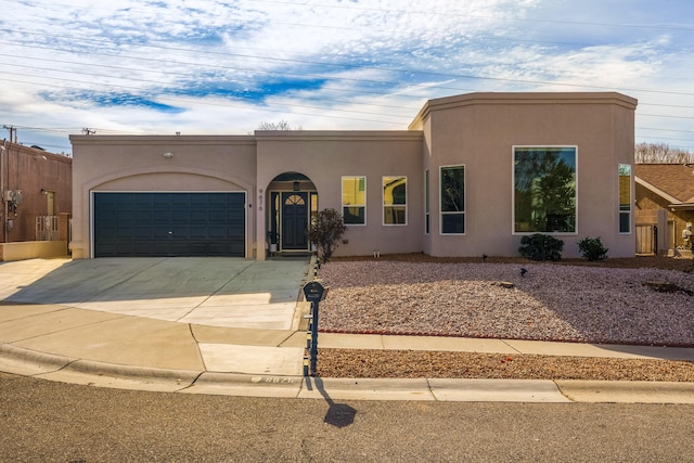 pueblo-style home featuring a garage