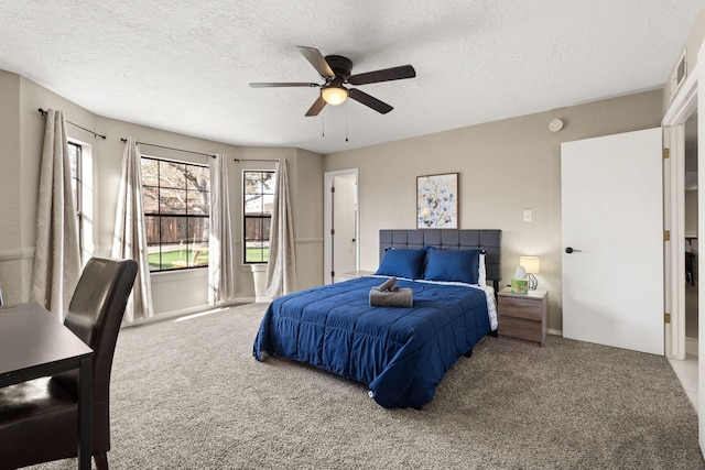 carpeted bedroom featuring ceiling fan, a textured ceiling, and multiple windows