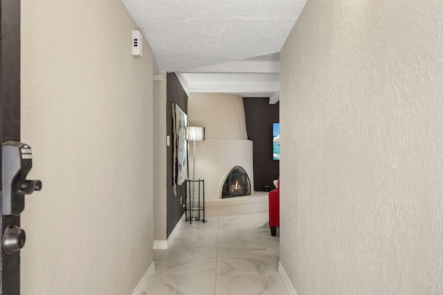 hallway with a textured ceiling