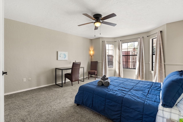 carpeted bedroom with ceiling fan and a textured ceiling