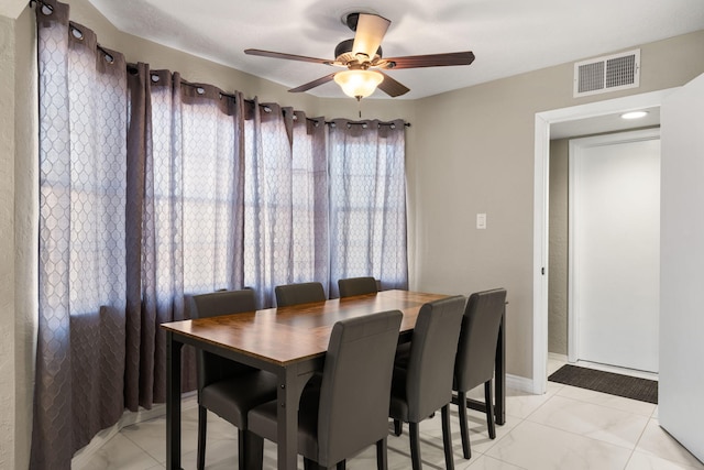 dining room featuring ceiling fan and light tile patterned flooring