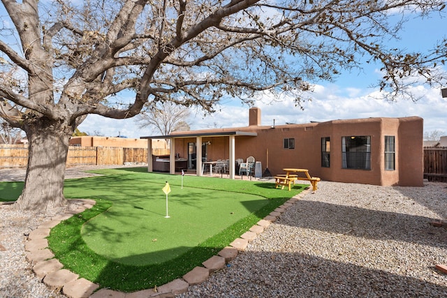 back of property with a patio area and a hot tub