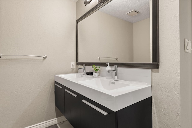 bathroom featuring vanity and a textured ceiling