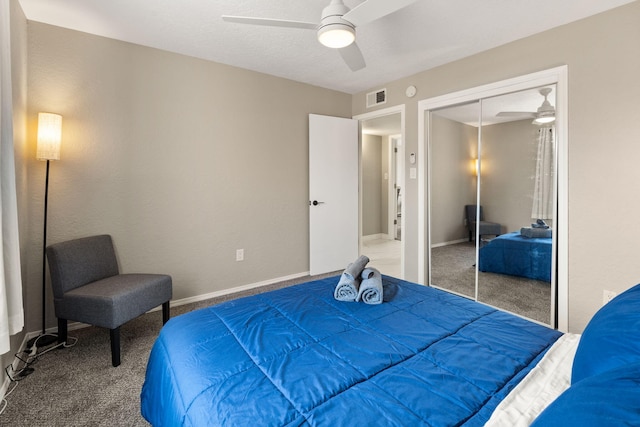 carpeted bedroom with ceiling fan and a closet