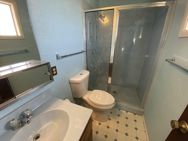 bathroom with vanity, toilet, and walk in shower