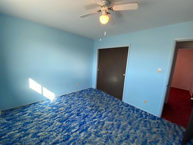 unfurnished bedroom with ceiling fan and carpet flooring