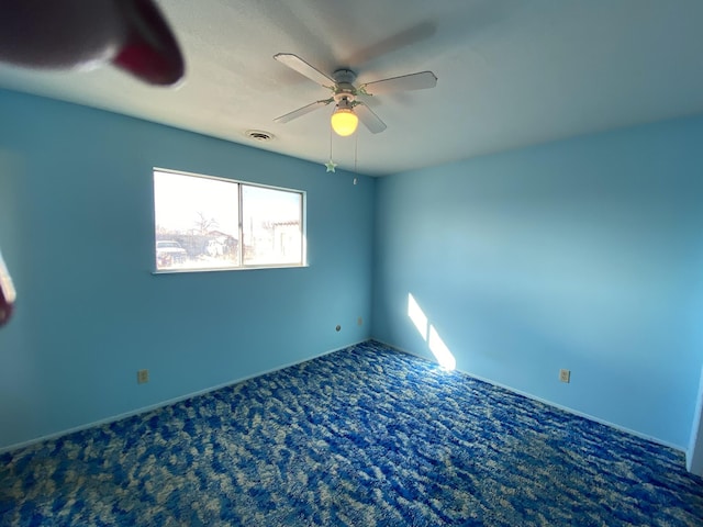 carpeted empty room with ceiling fan