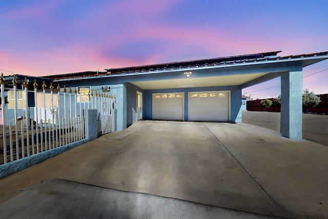 415 Wheeler Ave SE, Albuquerque, NM 87102 - view of front of property featuring fence, a garage, stucco siding, and concrete driveway