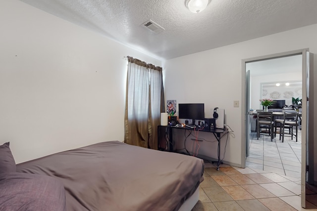 415 Wheeler Ave SE, Albuquerque, NM 87102 - bedroom featuring light tile patterned flooring and a textured ceiling