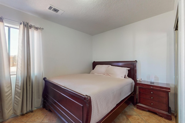 415 Wheeler Ave SE, Albuquerque, NM 87102 - bedroom featuring light tile patterned flooring and a textured ceiling