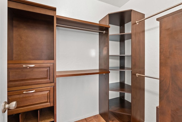 walk in closet with hardwood / wood-style floors