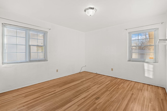 unfurnished room with light hardwood / wood-style floors