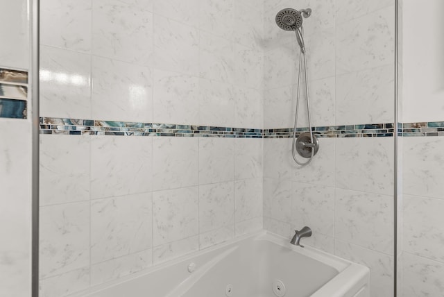 bathroom with tiled shower / bath combo and tile walls