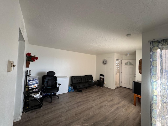 home office featuring a textured ceiling and wood finished floors