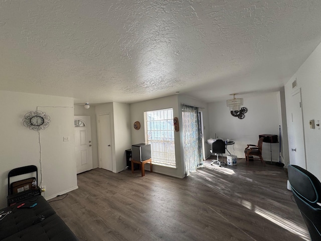 interior space with a textured ceiling and dark wood-type flooring