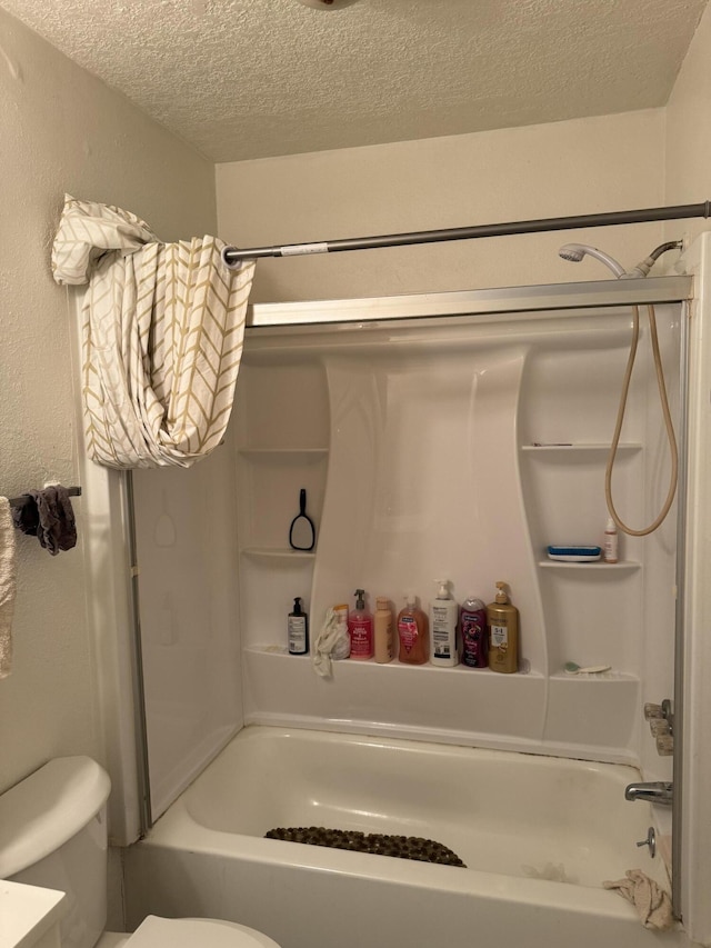 bathroom featuring a textured ceiling, toilet, shower / bathtub combination, and a textured wall