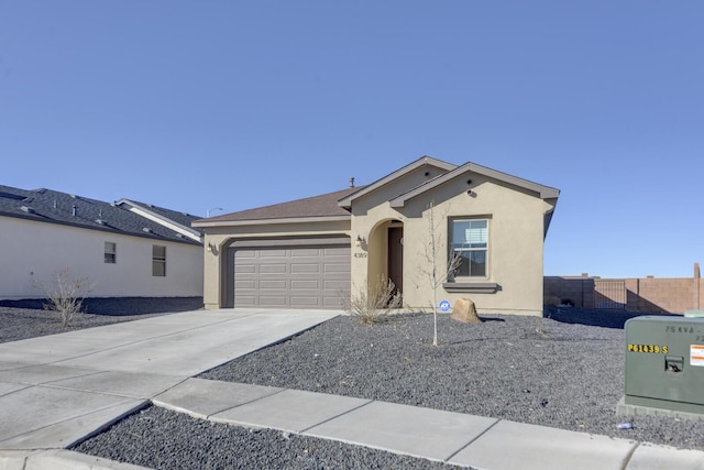 view of front of home featuring a garage, fence, concrete driveway, and stucco siding