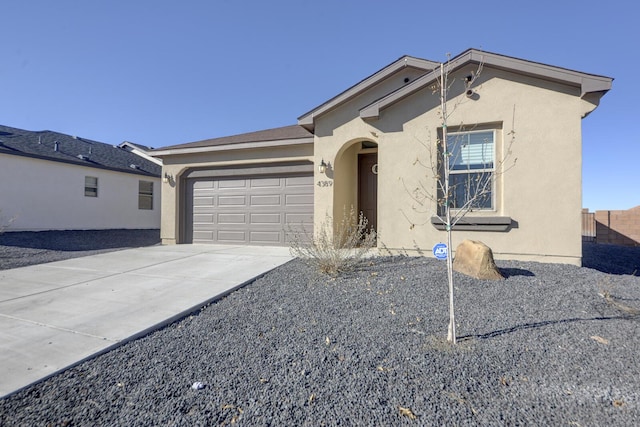 single story home featuring driveway, an attached garage, and stucco siding