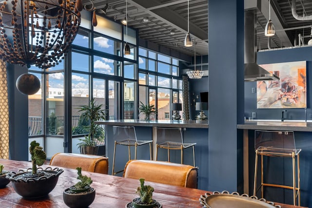 dining area featuring a towering ceiling