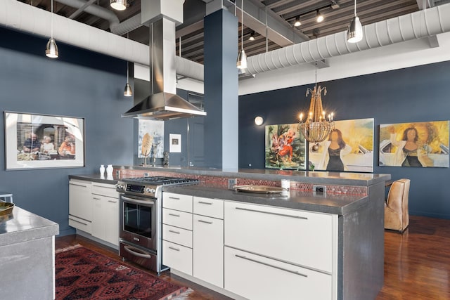 kitchen with hanging light fixtures, gas range, dark wood-type flooring, and white cabinets