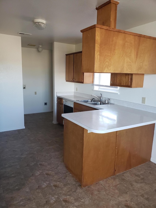 kitchen with dishwasher, kitchen peninsula, and sink