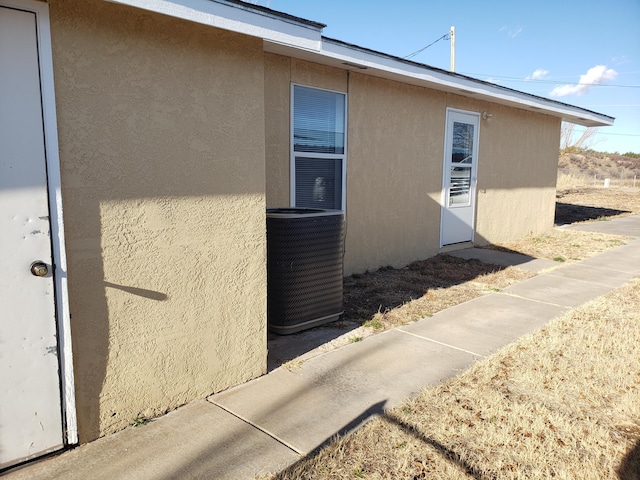 view of side of property featuring central AC