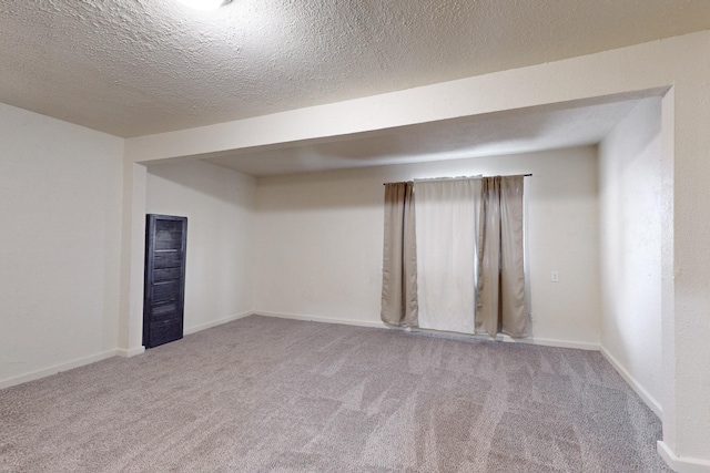 empty room featuring carpet flooring and a textured ceiling