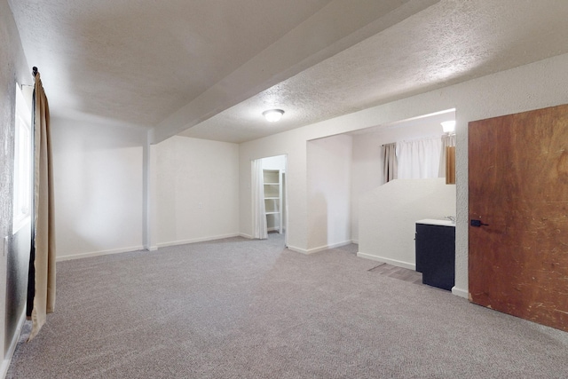 basement with carpet floors and a textured ceiling