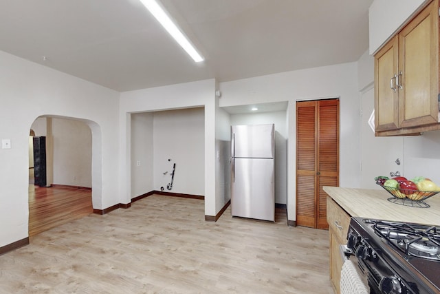 kitchen with light wood-type flooring and appliances with stainless steel finishes