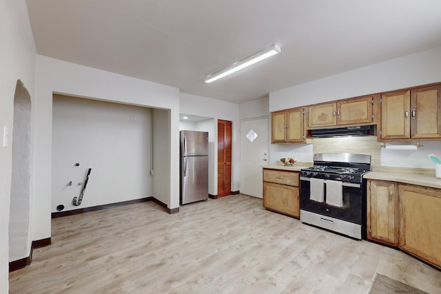 kitchen featuring light hardwood / wood-style floors, exhaust hood, and appliances with stainless steel finishes