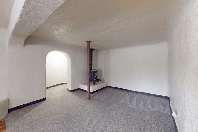 unfurnished living room with carpet floors and a textured ceiling