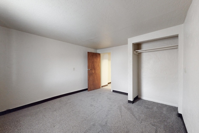 unfurnished bedroom with a closet, carpet, and a textured ceiling