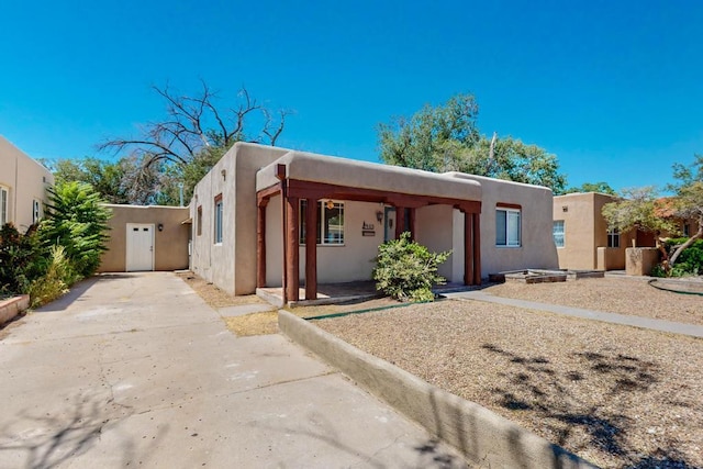 pueblo-style home with a carport