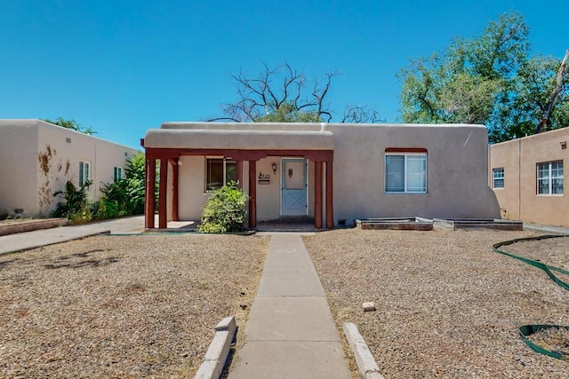 adobe home featuring a porch