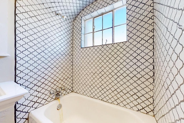 bathroom featuring washtub / shower combination