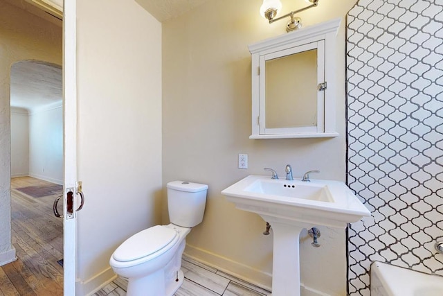 bathroom featuring toilet and sink