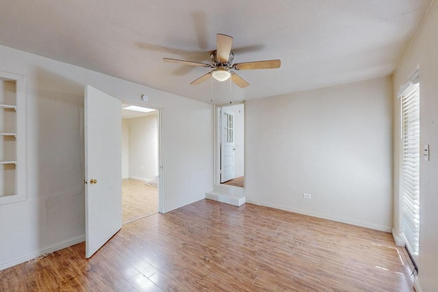 spare room featuring ceiling fan and light hardwood / wood-style flooring