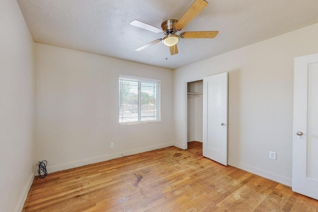 unfurnished bedroom with ceiling fan, a closet, and light wood-type flooring