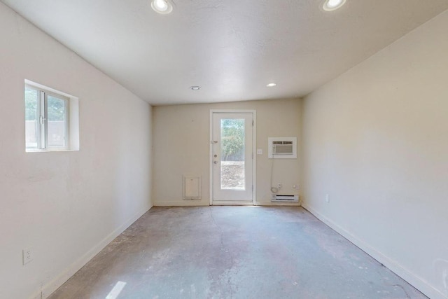 unfurnished room featuring a wall unit AC