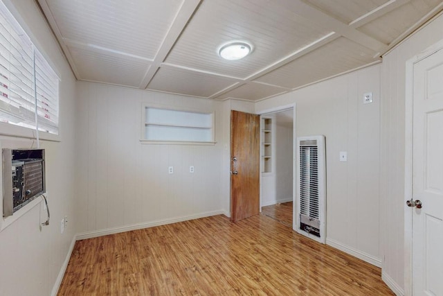 spare room with built in shelves, light hardwood / wood-style flooring, and cooling unit