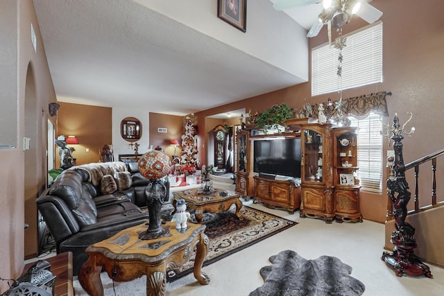 living room featuring ceiling fan, carpet floors, and a textured ceiling